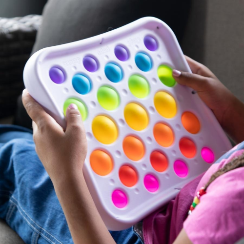 Colorful pop-it fidget toy held by a person