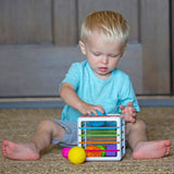 Child playing with a colorful toy on the floor