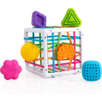 A colorful baby sensory toy activity cube with a white plastic frame, colorful elastic cords, and several textured sensory balls and shapes in yellow, orange, purple, green, pink, and blue, shown on a white background.