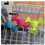 Colorful shapes in a dishwasher rack .
