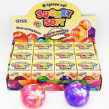 A display box of Sugary Soft Squeeze Balls. Three marbled  balls are placed in front of the box on a clean white background.