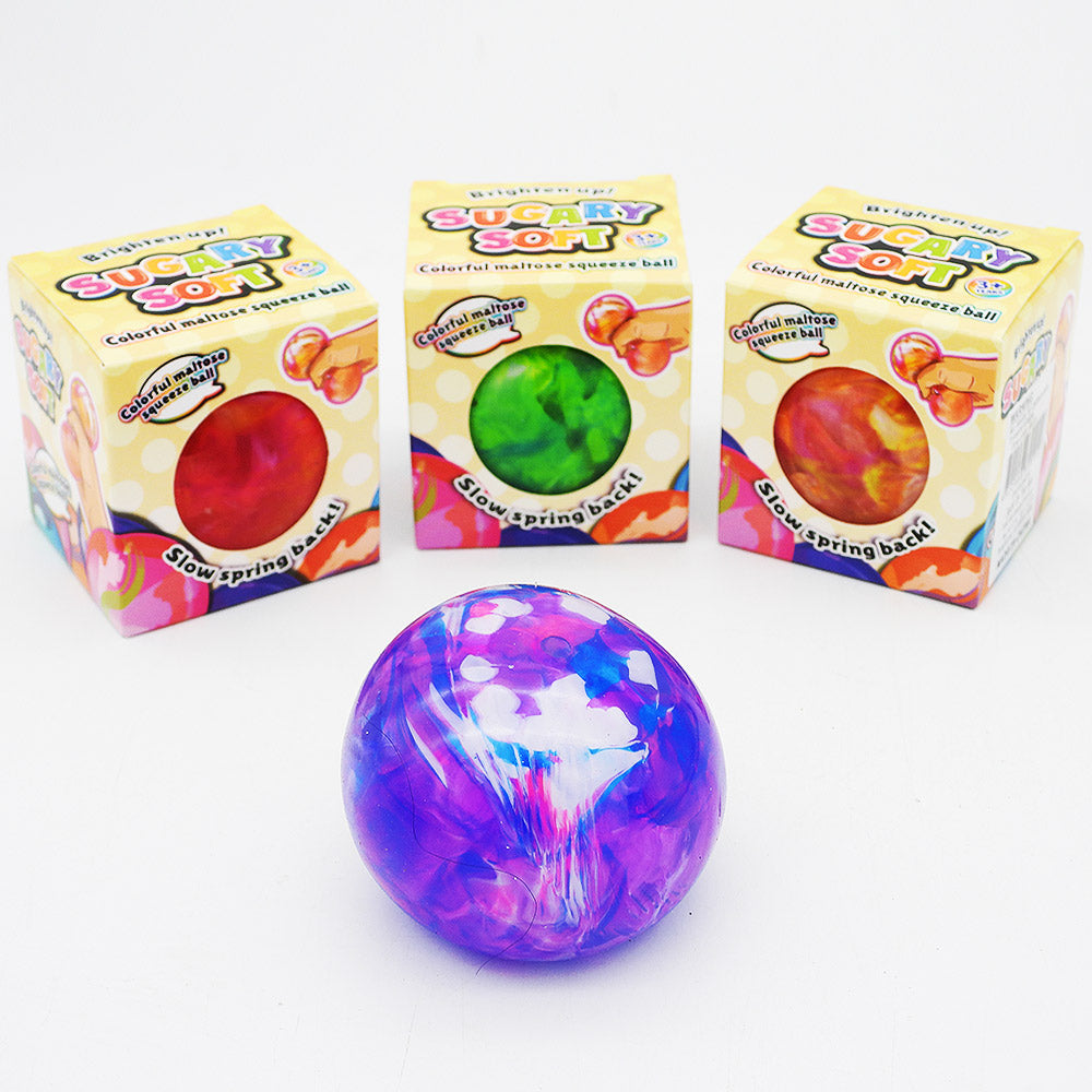Three colorful squeeze balls in front of their retail boxes on a white background. 
