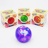 Three colorful squeeze balls in front of their retail boxes on a white background. 