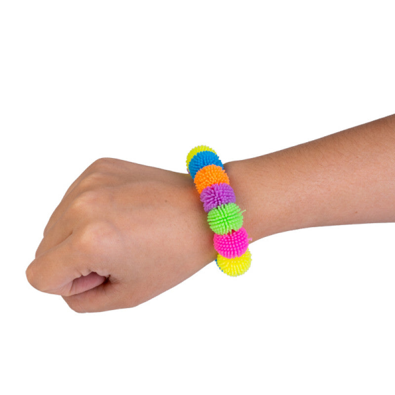 Colorful textured bracelet on a wrist against a white background