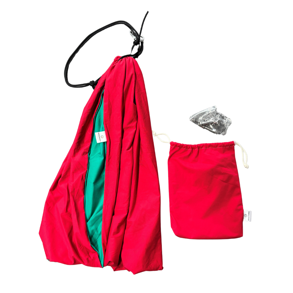Red and green fabric swing folded with bag and fittings beside