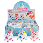 Display box of Unicorn Kingdom squishy bubble unicorn toys with packaging and toys in front.
