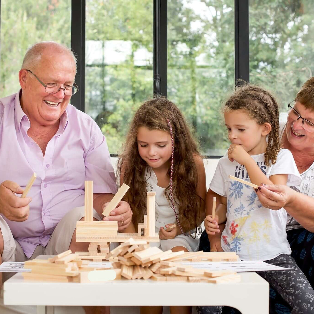 Family playing with wooden toys in a bright room